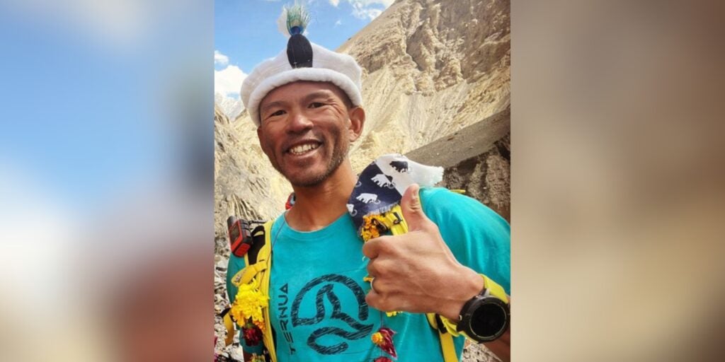 Kazuya Hiraide smiles, giving a thumbs up, while in basecamp after a climb.