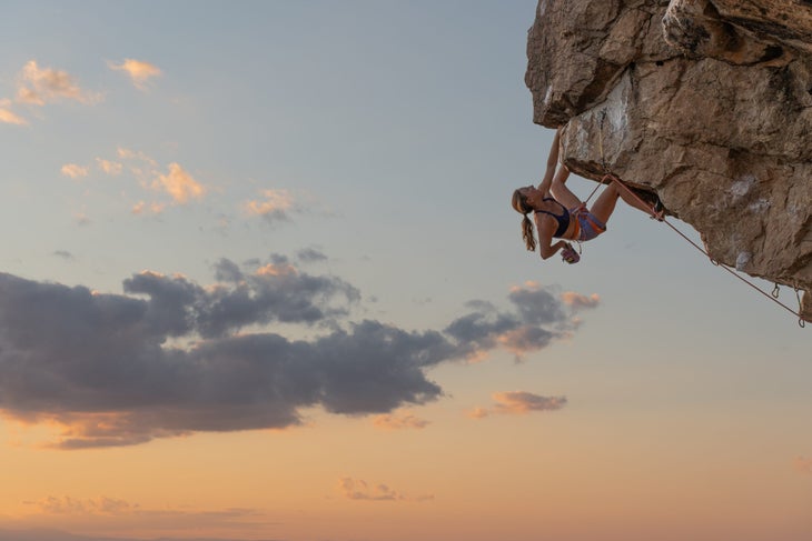 Michaela Kiersch climbing a steep seaside cliff in Vermont